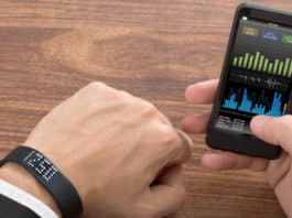 Smart Wristband And Cellphone Showing Fitness Status