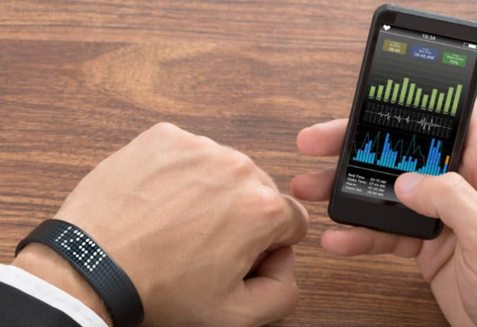 Smart Wristband And Cellphone Showing Fitness Status