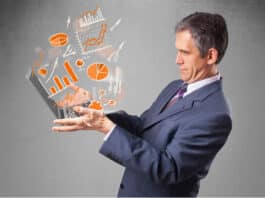 Businessman in suit holding notebook with graphs and statistic