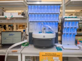 A laptop running PeptiVerse, at left, next to machines used to synthesize peptides, center and at right. Researchers can use PeptiVerse to predict the properties of peptides before incurring the time and expense required to synthesize them. Credit: Sylvia Zhang, Penn Engineering