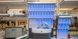 A laptop running PeptiVerse, at left, next to machines used to synthesize peptides, center and at right. Researchers can use PeptiVerse to predict the properties of peptides before incurring the time and expense required to synthesize them. Credit: Sylvia Zhang, Penn Engineering