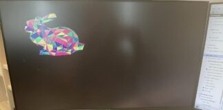 Basys3 FPGA board rendering a colorful low-poly 3D rabbit model on a Dell monitor, running the TinyGPU graphics pipeline