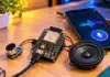 Open-Source Hermes Turns ESP32 Into Voice Assistant An ESP32 board connected to a microphone and speaker for a DIY voice assistant (AI illustrated).