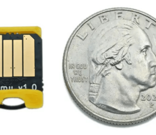 The Bitmerse Romu next to a coin, highlighting its ultra-compact $15.5 \times 12\text{ mm}$ form factor designed to fit entirely inside a USB-A port